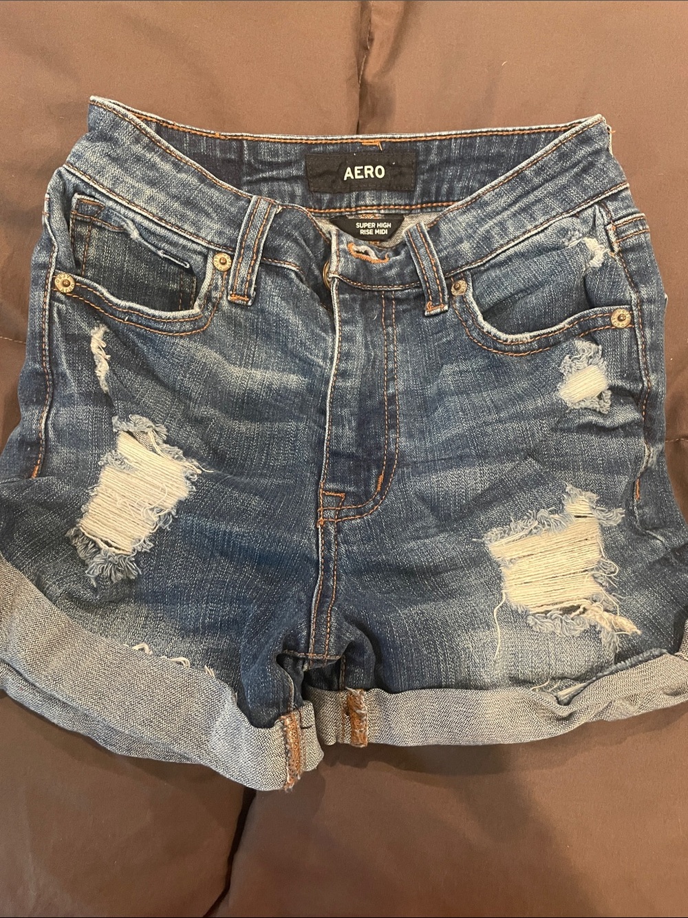 AERO High-Rise Distressed Denim Shorts in Blue